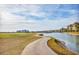 Concrete path winds along the golf course and lake at 6438 Watercrest Way # 204, Lakewood Ranch, FL 34202