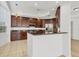 Kitchen features dark wood cabinets, stainless steel appliances, and a breakfast bar at 6438 Watercrest Way # 204, Lakewood Ranch, FL 34202