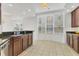 Eat-in kitchen with dark wood cabinets, stainless steel appliances, and tile flooring at 6438 Watercrest Way # 204, Lakewood Ranch, FL 34202