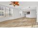 Living room with hardwood floors, ceiling fan, and views of the lake at 6438 Watercrest Way # 204, Lakewood Ranch, FL 34202