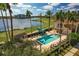 Resort-style pool with shaded seating and a lakeside view at 6438 Watercrest Way # 204, Lakewood Ranch, FL 34202