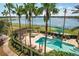 Relaxing pool area with lake view and palm trees at 6438 Watercrest Way # 204, Lakewood Ranch, FL 34202