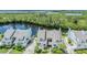 Aerial view of waterfront community with townhomes, lush landscaping, and waterway at 111 Tidy Island Blvd # 111, Bradenton, FL 34210