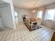 Bright dining room features a wood table, tile floors, and a decorative chandelier at 111 Tidy Island Blvd # 111, Bradenton, FL 34210