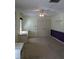 Bedroom featuring a large closet, ceiling fan, neutral carpet, and a colorful accent wall at 4160 Fruitville Rd # 13, Sarasota, FL 34232
