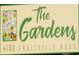 Community sign for The Gardens with floral details and address at 4160 Fruitville Rd # 13, Sarasota, FL 34232
