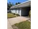 Light gray condo building with a gray roof and small front yard at 4160 Fruitville Rd # 13, Sarasota, FL 34232