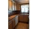 Kitchen with wood cabinets, tile countertops, and tile floor at 4160 Fruitville Rd # 13, Sarasota, FL 34232