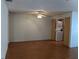 Living room with wood flooring, ceiling fan, and access to laundry at 4160 Fruitville Rd # 13, Sarasota, FL 34232