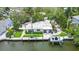 Aerial view of waterfront home with boat lift and lush landscaping at 562 Juan Anasco Dr, Longboat Key, FL 34228