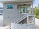 Modern gray house exterior with stairs and white fence at 2430 Floyd St, Sarasota, FL 34239