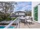Private balcony with outdoor furniture and partial pool view at 2430 Floyd St, Sarasota, FL 34239