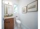 Contemporary small bathroom with wood vanity and terrazzo floors at 2430 Floyd St, Sarasota, FL 34239