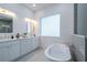 Elegant bathroom with a freestanding soaking tub and a walk-in shower at 2430 Floyd St, Sarasota, FL 34239