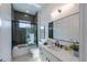 Modern bathroom with a soaking tub, tiled shower, and floating vanity at 2430 Floyd St, Sarasota, FL 34239