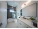 Modern bathroom with soaking tub, tiled shower, and floating vanity at 2430 Floyd St, Sarasota, FL 34239