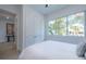 Bright bedroom with a queen bed, large window, and access to another room at 2430 Floyd St, Sarasota, FL 34239