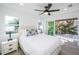 Bedroom with queen bed and private balcony access and ceiling fan at 2430 Floyd St, Sarasota, FL 34239