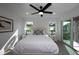 Bedroom with queen bed, private balcony access and ceiling fan at 2430 Floyd St, Sarasota, FL 34239