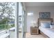 Bedroom with sliding glass doors that open onto a private balcony at 2430 Floyd St, Sarasota, FL 34239