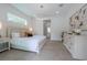 Spacious bedroom with large bed, dresser, and access to the bathroom at 2430 Floyd St, Sarasota, FL 34239