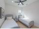Well lit bedroom with two twin beds and ceiling fan at 2430 Floyd St, Sarasota, FL 34239