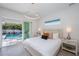 Main bedroom with sliding glass doors opening to a pool view at 2430 Floyd St, Sarasota, FL 34239