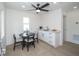 Small breakfast nook with modern white cabinets and black table at 2430 Floyd St, Sarasota, FL 34239