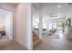 Bright hallway with stairs leading upstairs and view of living room at 2430 Floyd St, Sarasota, FL 34239