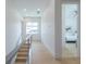 Bright hallway with light wood floors, modern railing, and access to bedrooms at 2430 Floyd St, Sarasota, FL 34239