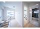 Light hallway with wood floors and access to bedroom and bathroom at 2430 Floyd St, Sarasota, FL 34239