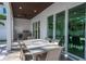 Covered patio with outdoor dining furniture and adjacent grilling area at 2430 Floyd St, Sarasota, FL 34239