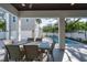 Relaxing pool area with patio furniture and view of the house at 2430 Floyd St, Sarasota, FL 34239