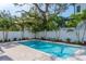 Private, inviting pool with a surrounding fence and tropical plants at 2430 Floyd St, Sarasota, FL 34239