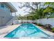 Relaxing rectangular pool, surrounded by lush landscaping at 2430 Floyd St, Sarasota, FL 34239