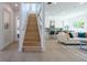 Light-filled entryway with a modern staircase leading to the upper level at 2430 Floyd St, Sarasota, FL 34239