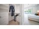 Bright walk-in closet with built-in shelving and a view of the bedroom and pool at 2430 Floyd St, Sarasota, FL 34239