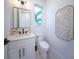 Chic powder room featuring white cabinetry and a geometric tile floor at 2446 Floyd St, Sarasota, FL 34239