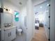 Small modern bathroom with white vanity, hexagon tile floor, and stylish mirror at 2446 Floyd St, Sarasota, FL 34239