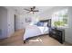 Spacious bedroom with light wood floors, ceiling fan, and large windows at 2446 Floyd St, Sarasota, FL 34239