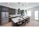 Modern kitchen with dark cabinetry, white countertops, and island seating at 2446 Floyd St, Sarasota, FL 34239