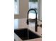 Modern kitchen sink with black faucet and white countertop at 2446 Floyd St, Sarasota, FL 34239