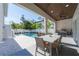 Inviting pool area with covered patio and outdoor dining at 2446 Floyd St, Sarasota, FL 34239