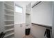 Bright walk-in closet with custom shelving and rods at 2446 Floyd St, Sarasota, FL 34239