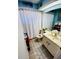 Well-lit bathroom featuring a toilet, shower, and vanity at 4419 Muirfield Dr, Bradenton, FL 34210