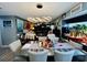 Open concept dining room with modern light fixture and seating for four at 4419 Muirfield Dr, Bradenton, FL 34210