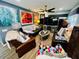 Relaxing living room featuring comfy seating and large artwork at 4419 Muirfield Dr, Bradenton, FL 34210