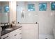 Spa-like bathroom with marble tile, walk-in shower, and modern vanity at 2420 Floyd St, Sarasota, FL 34239
