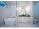 Elegant bathroom with marble tile, a freestanding tub, and a walk-in shower at 2420 Floyd St, Sarasota, FL 34239