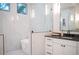 Spa-like bathroom with marble tile, a soaking tub, a walk-in shower, and modern vanity at 2420 Floyd St, Sarasota, FL 34239